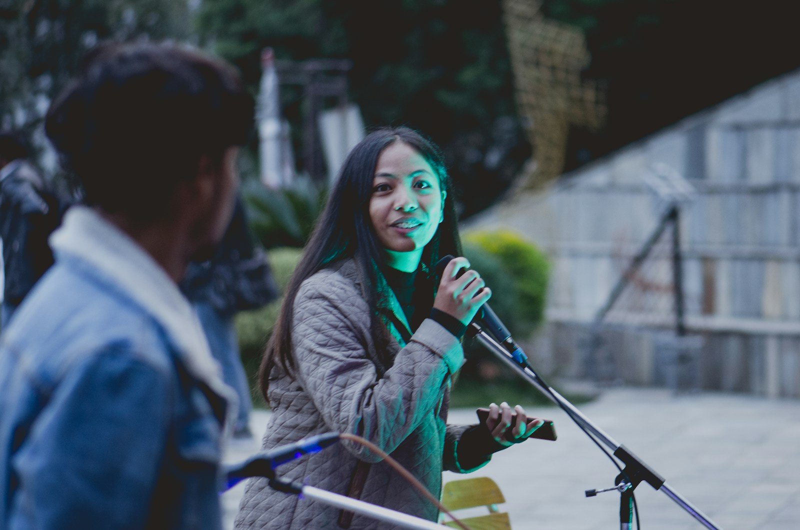 selective focus photo of woman holding microphone